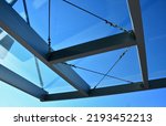 Small photo of strut, suspended glass roof above the building entrance. bus station, railway station. cable wind braces. aluminum construction with windows above the pergola