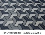 Small photo of concrete paving with geometric shapes and shades of gray creates a three-dimensional impression of the space. unpleasant for people suffering from dizziness and disorientation