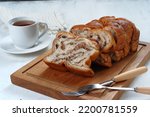 Small photo of Chocolate Babka or Brioche Bread-chocolate swirl bread, sliced on white background.