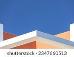 Small photo of abstract architecture background. Close up geometric angular structure detail walls fragments. White, orange brown walls against blue sky. Contemporary minimalist architectural photography. Exterior.