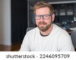 Small photo of Close up portrait of smiling 30s Caucasian man look at camera posing in own flat or apartment. Profile picture of happy 30s male renter or tenant in new home. Real estate, rental concept.
