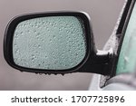 Rain drops on car side mirror