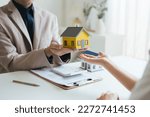 Small photo of Real estate agent and realtor general liability insurance businessman professional discussing and consultant with house toy model building before sign a contract with law concept.