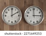 Two clocks, one showing two o'clock, the other showing three o'clock.  Time change symbol. Daylight saving time. Moving the hands forward.