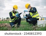 Small photo of Two Environmental Engineers Inspect Water Quality and Take Water Samples Notes in The Field Near Farmland, Natural Water Sources maybe Contaminated by Toxic Waste or Suspicious Pollution Sites.