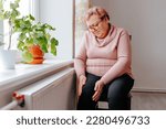 Small photo of Painful Struggle An Overweight Woman Suffers with Leg Pain at Home, A senior woman holding onto her leg, wincing in pain due to leg ache, a reminder of the struggles of aging and being overweight