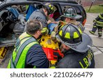 Small photo of Lower Burrell, Pa., USA - May 3, 2018: MOCK DUI TRAINING for fire, police, and ems paramedics at a staged car accident with injuries and fatality, parents being restrained