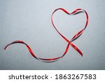 red ribbon heart on a gray... | Shutterstock . vector #1863267583