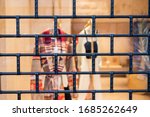 Small photo of Rustic metal lattice background. Locked up / locked down / shut down / closed concept. Quarantine. Closed and shuttered entrance to department store during COVID-19