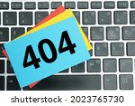 laptop keyboard, colored paper with the number 404
