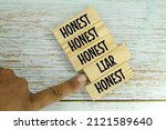 Small photo of wooden boards with honest and liar words. chosen honestly