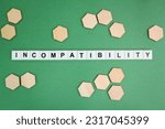 Small photo of letter of the alphabet with the word incompatibility. incompatible concepts