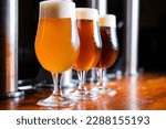 Small photo of Glasses of light and dark beer on a pub background. draft beer, craft beer, imported beer