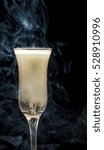 Small photo of glass of champagne with smoke. Tempest in a teapot