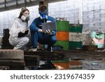 Small photo of Team inspector chemical and hazmat wearing protective mask using laptop and write note on clipboard. Wastewater chemical residue in factory. Analysing harmful substances to human body environment.