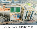 Small photo of Dubai, UAE - May 29, 2019: It is a view of Dubai Marina and rooftop of abuilding apartment on promenade. It is Falcon hotel. It is the Perl Marina hotel.
