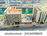 Small photo of Dubai, UAE - May 29, 2019: It is view of Dubai Marina and rooftop of building apartment on promenade. It is Falcon hotel. It is Perl Marina hotel.