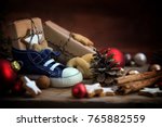 Children's shoe with sweets and gifts for St. Nicholas Day on December 6th at Christmas time on rustic wood, traditional custom in Germany called Nikolaus, selected focus, narrow depth of field