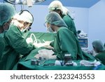 Small photo of Medical team of surgeons in hospital working surgical intervention.Surgery operating room with electrocautery equipment for cardiovascular emergency save lives.Surgeon gloved hands hold the instrument