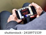 Person got potential deep fake content message during watching a footage on his mobile phone. Selective focus