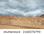 a sand quarry, in the photo a sand quarry and a gray sky in the background.