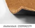 Small photo of Natural brown coconut fiber doormat. Plain natural dry carpet and dirt outside your entrance, Detail, closeup of fiber and base on white background.