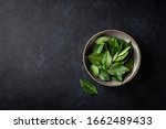 bay leaves on a black background, top view, place for text.