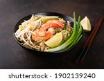 Pad Thai with shrimp on a stone background, selective focus