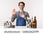 Small photo of Barista, cafe worker and bartender concept. Portrait of devoted young male employee swear make only good tasty coffee, hold hand on heart make oath, promise he is professional