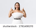 Small photo of Beauty, fashion and social media concept. Happy smiling asian woman having fun participating in internet pillow challenge, making dress from pillow and belt cinching around waste, show thumbs-up