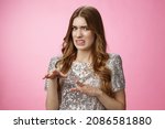 Small photo of Disgusted reluctant young arrogant glamour woman telling about creepy man cringing aversion grimacing dislike gesturing displeased, expressing antipathy standing pink background freaked-out