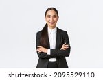 Successful young asian businesswoman in suit ready do business, cross arms confident and smiling. Female entrepreneur determined to win. Happy saleswoman talking to clients, white background