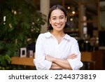 Portrait of smiling asian girl in white collar shirt, working in cafe, managing restaurant, looking confident and stylish.