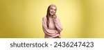 Small photo of Talkative attractive glamour young 20s european woman wearing sweater, knitted headband tilting head looking away smiling curious, enjoying pleasant conversation via smartphone, talking to friend.