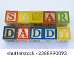 Small photo of The term sugar daddy visually displayed on a clear background with copy space