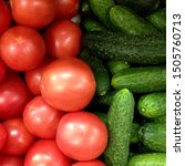 Small photo of Macro photo of a vegetable red tomato and green cucumbers. Fruit vegetables tomatoes and cucumbers. Background of pink tomatoes with green cucumbers