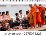 Small photo of Luang Prabang, Laos - 05 May, 2023 - Buddhist novice monks receive alms (Tak Bat), Luang Prabang, Laos