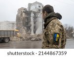 Small photo of Bodoryanca , kyiv Oblast, Ukraine 04-11-2022 A Ukrainian reservist looks at a building destroyed by a Russian missile in the city of Barranca.