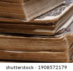 uneven corner of old books with brown textured paper and torn cover.vintage paper texture. selective focus. High quality photo