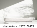 Small photo of Luxury marble table with plant shadow on white wall and stone podium for product placement display. Trendy neutral aesthetic mockup template for beauty and cosmetics scene.