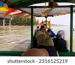 Small photo of The people is riding the boat on the beach. Indonesia, June 12, 2023, pengunjung wisata pantai widuri pemalang, sedang naik perahu nelayan dengan biayar ride a fishing boat, as a tourist destination