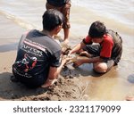 Small photo of The people at beach. Indonesia, June 22, 2023, anak anak dan pengnjung, wisatawan berlibur dan bermain ombak pasir air pantai widuri, pantai ombak kecil, pantai utara pula jawa, ombak tenang landai