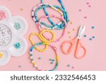 Children's needlework and beading. Handmade bracelets and different beads for children's crafts. DIY art activity for kids. Motor skills, creativity and hobby.