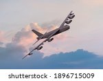 Boeing B52 Bomber of the United `states Airforce (USAF) at sunset. B-52 nuclear and heavy bomber banking towards the camera at sunset. New engine contract from Rolls Royce
