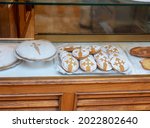 Small photo of SANTIAGO DE COMPOSTELA, SPAIN - September 13, 2020: Traditional Saint Jakob's cakes at the bakery showcase in the Santiago de Compostela, Galicia, Spain.