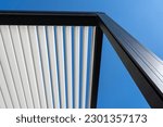 Small photo of eco friendly bioclimatic aluminum pergola shade structure, awning and patio roof