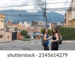 Small photo of QUITO, ECUADOR - MARCH 10, 2022: Mother and daughter in La Floresta area, which has developed a reputation for being one of the most beguiling neighborhoods of any city in South America.