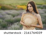 Woman without bra standing in a lavender field