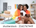 Diversity African American and Asian Married couples Lesbian LGBTQ. Married homosexual show their passports to prepare for a trip together.Sexual equality,LGBT Pride month,Parade celebrations concept.