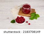 Jar of raspberry jam and fresh berries. Homemade jam